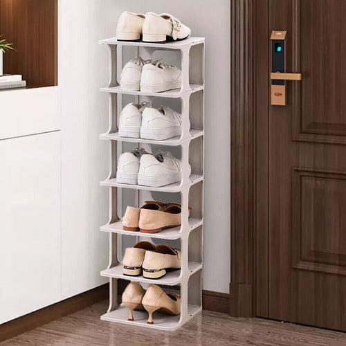 White shoe rack with various shoes on shelves in a room setting.