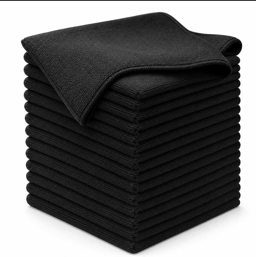 A stack of black microfiber cleaning cloths with one cloth folded on top, photographed on a clean white background.